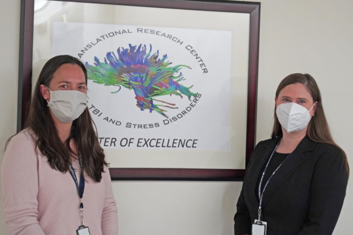 Dr. Francesca Fortenbaugh and Dr. Jennifer Gustafson standing in front of the TRACTS logo